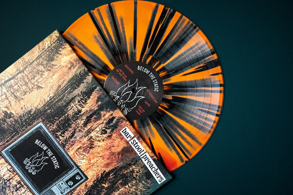 Vinyl record with orange and black splatter pattern.